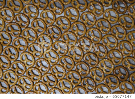 Dry mini salted pretzels as background. 65077147