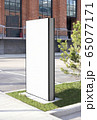 Blank white vertical pylon stand mockup brick building, side view Blank white vertical pylon stand mockup brick building, side view 65077171