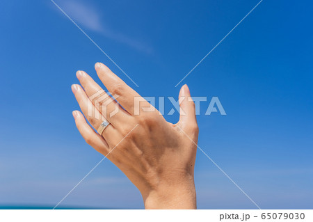 Coronavirus is over. Quarantine weakened. Take off the mask. Now you can travel. Female hand with a 65079030