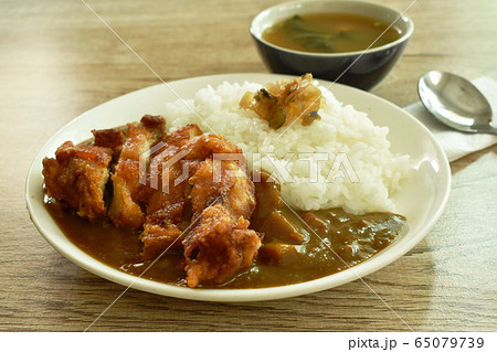 deep fried chicken dressing with Japanese curry on rice topping slice pickled cabbage deep fried chicken dressing with Japanese curry on rice topping slice pickled cabbage 65079739