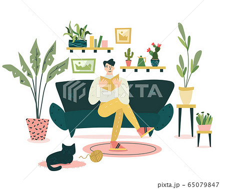 Guy is sitting on the coach and reading an interesting book in cozy and nice living room.  65079847
