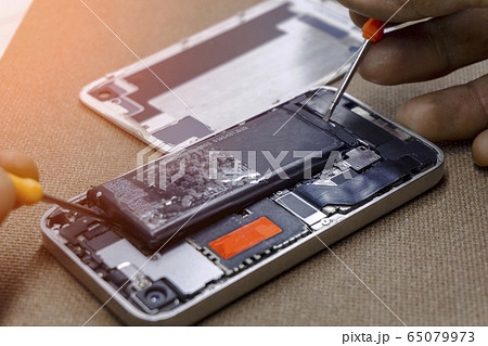Battery removing by professional technician repairman for battery smartphone repair 65079973
