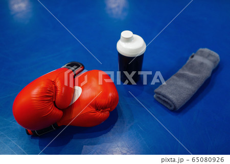 Boxing gloves, pads and equipment on ring, nobody Boxing gloves, pads and equipment on ring, nobody 65080926