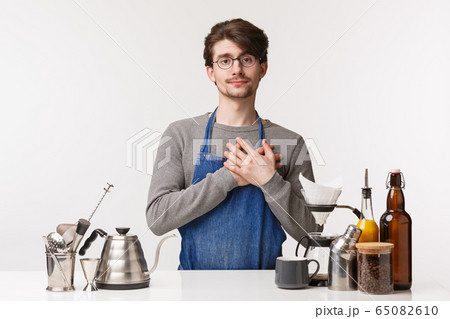 Barista, cafe worker and bartender concept. Touched and pleased caucasian guy in apron working cafe, touch heart and sighing looking at his soulmate enter shop, making coffee, white background Barista, cafe worker and bartender concept. Touched and pleased caucasian guy in apron working cafe, touch heart and sighing looking at his soulmate enter shop, making coffee, white background 65082610