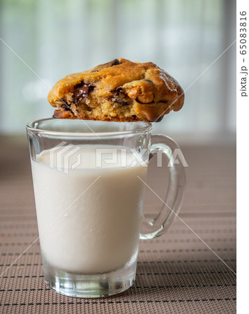 Chewy chocolate chip soft cookie on cup of milk 65083816