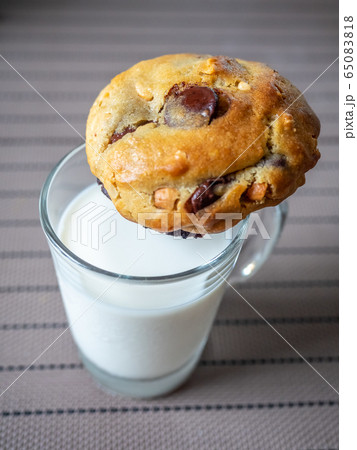 Chewy chocolate chip soft cookie on cup of milk 65083818
