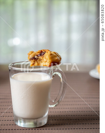 Chewy chocolate chip soft cookie on cup of milk 65083820
