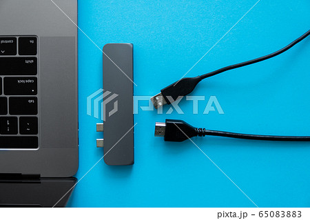 Laptop with USB Type-C adapter with unpluged USB cables. The USB adapter under the Type-C connector for laptop. Multiport station for laptop with multiple different ports. Hub Converter. Laptop with USB Type-C adapter with unpluged USB cables. The USB adapter under the Type-C connector for laptop. Multiport station for laptop with multiple different ports. Hub Converter. 65083883