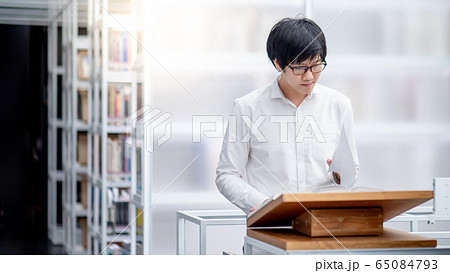Asian man student reading recommend book in Asian man student reading recommend book in 65084793
