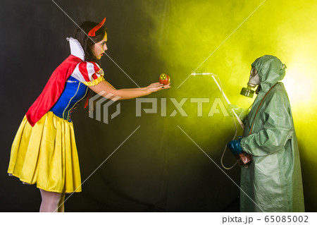 Woman holding hazardous radioactive apple. Nuclear and radiation measurement concept. 65085002