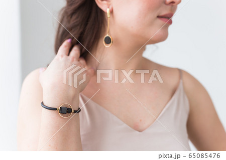 Close-up portrait of beautiful young woman with elegant hairstyle and luxurious jewelry and bijouterie. 65085476