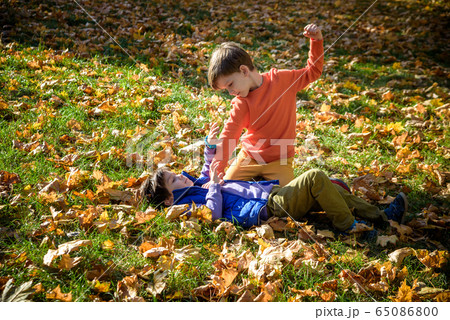 Two boys fighting outdoors. Friends wrestling in 65086800
