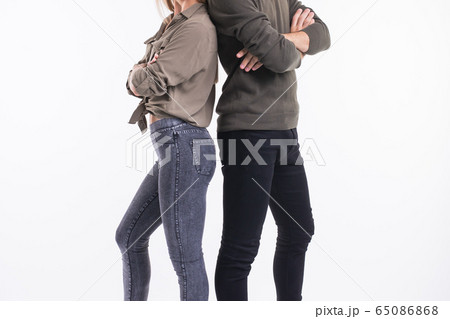 Close-up of couple woman and man standing back to back. They look very sad, disappointed with each other, isolated on white background. Marriage, relationship problems. Human emotions, expressions 65086868