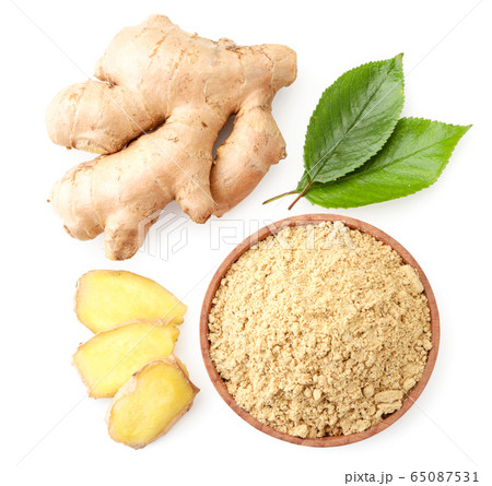 Ginger root, sliced and ground with green leaves Ginger root, sliced and ground with green leaves 65087531