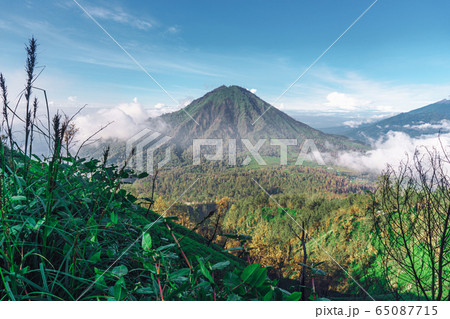 Photograph of high volcano with clouds on Java 65087715