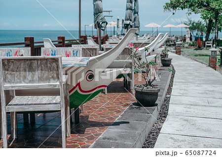 treet cafe with umbrellas and tables in sea 65087724