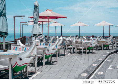 treet cafe with umbrellas and tables in sea 65087725