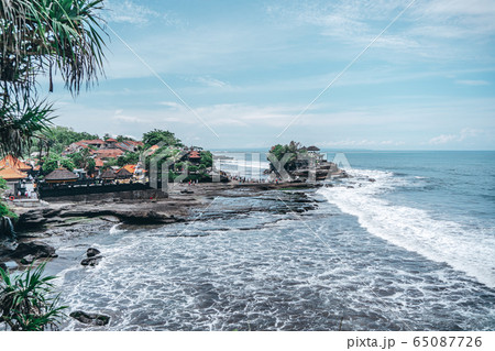 large waves crashing into large rocks large waves crashing into large rocks 65087726