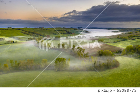 Lush green River valley Tuscany 65088775