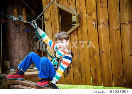 Boy climbing up into a treehouse. Healthy games Boy climbing up into a treehouse. Healthy games 65088905