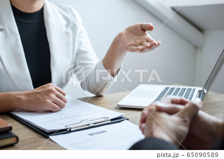 Employer or recruiter holding reading a resume 65090589