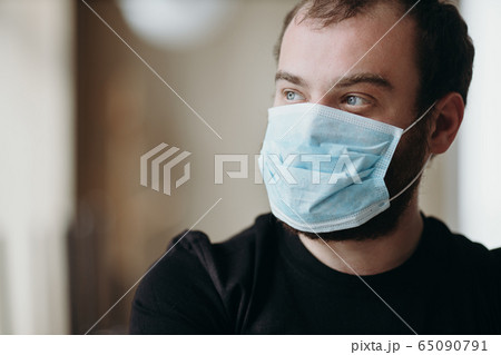 Portrait of man wearing a protective medical face mask to prevent infection of coronavirus. Portrait of man wearing a protective medical face mask to prevent infection of coronavirus. 65090791