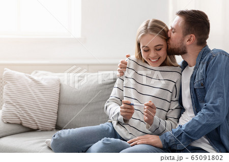 Young couple happy about positive results of pregnancy test 65091802
