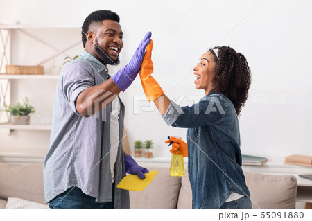 Black Spouses Giving High Five To Each Other After Spring-Cleaning Home Black Spouses Giving High Five To Each Other After Spring-Cleaning Home 65091880