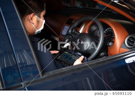 Checking a car engine OBD for repair at car garage 65093110