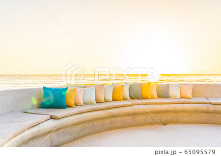 Comfortable pillow on sofa chair around outdoor patio with sea ocean beach view Comfortable pillow on sofa chair around outdoor patio with sea ocean beach view 65095579