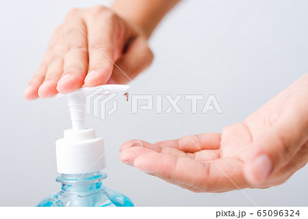 Close up woman applying press dispenser sanitizer Close up woman applying press dispenser sanitizer 65096324