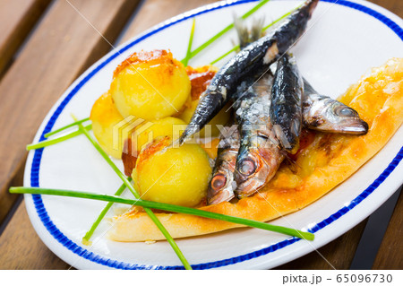 Deliciously fried sprats with scone and potato croquettes on plate Deliciously fried sprats with scone and potato croquettes on plate 65096730