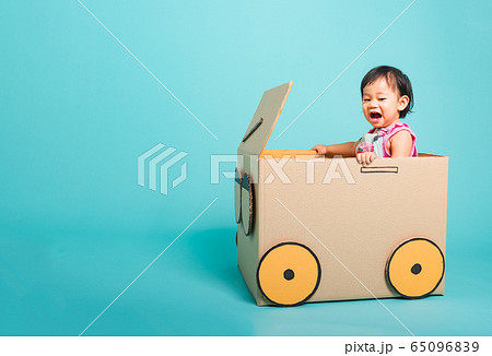 Baby girl smile in driving play car creative by a 65096839