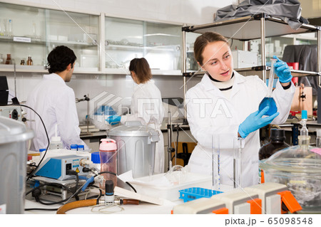 Female student examining chemical substances 65098548