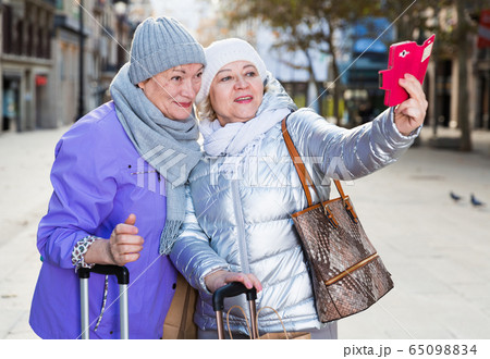 Senior females travelers taking selfie 65098834