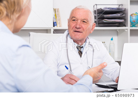 Male doctor with female client Male doctor with female client 65098973