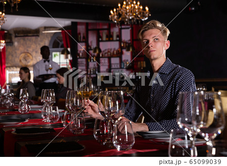 Man drinking wine in luxury restaurant Man drinking wine in luxury restaurant 65099039