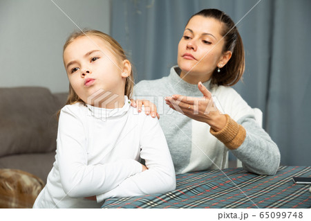 Unhappy young woman discuss conflict with small daughter 65099748