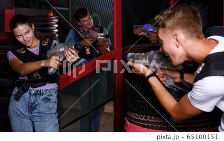 Group portrait of jolly people with laser guns Group portrait of jolly people with laser guns 65100151