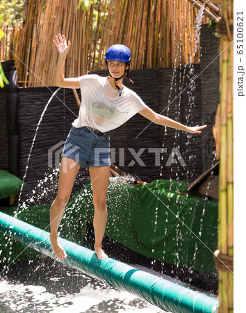 Girl passing horizontal bar with obstacles Girl passing horizontal bar with obstacles 65100621