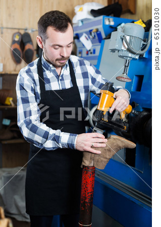 Male worker repairing shoe Male worker repairing shoe 65101030