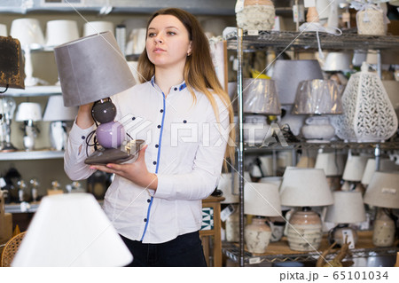 woman is looking on table lamps 65101034