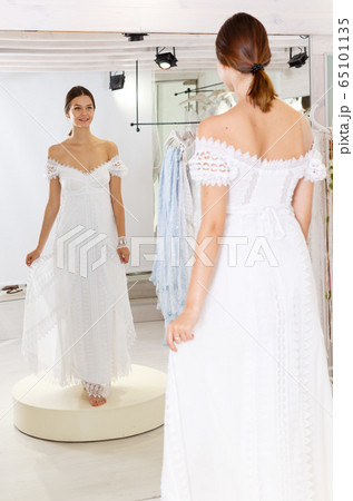 Woman flaunting dressed in wedding gown 65101135