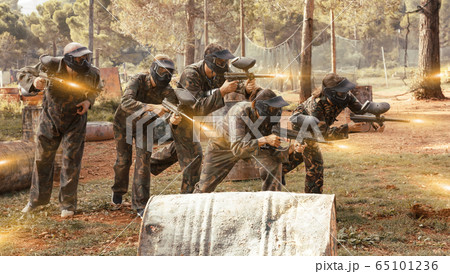 Group of people playing paintball Group of people playing paintball 65101236