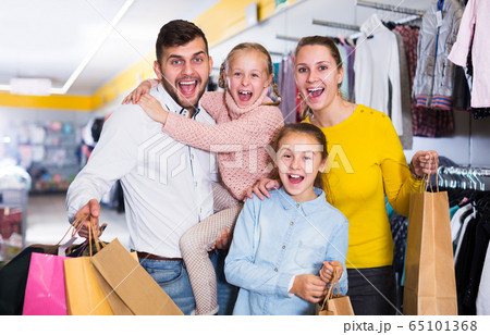 Family after shopping in store Family after shopping in store 65101368