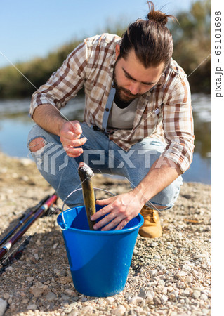 Lucky fisherman caught a trout fish 65101698