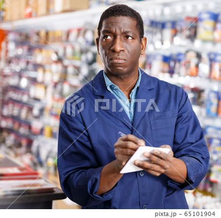 African American worker taking inventory of goods African American worker taking inventory of goods 65101904