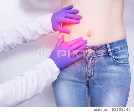 The doctor conducts a visual inspection and palpation of the patient s abdomen on suspicion of acute apendicitis and inflammation, abdominal pain, medical 65105240