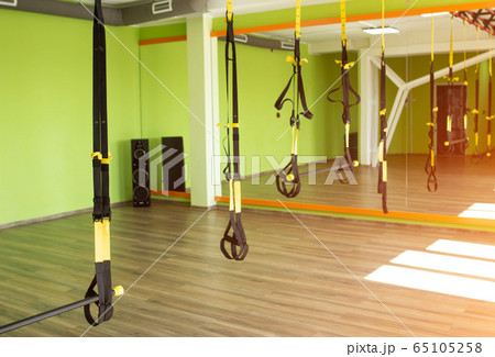 Modern fitness room for practicing hinges on the loops for strengthening the muscular corset and burning calories, copy space 65105258