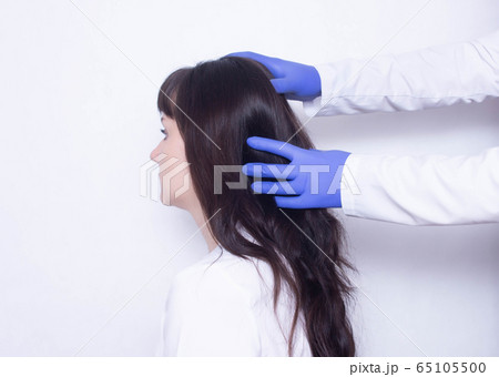 The doctor diagnoses and treats a young caucasian female patient with headaches and dizziness, migraines, copy space The doctor diagnoses and treats a young caucasian female patient with headaches and dizziness, migraines, copy space 65105500
